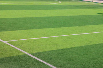 Wall Mural - The white Line marking on the artificial green grass soccer field