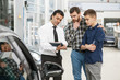 © Zoriana - Handsome mature man and his son buying a new car