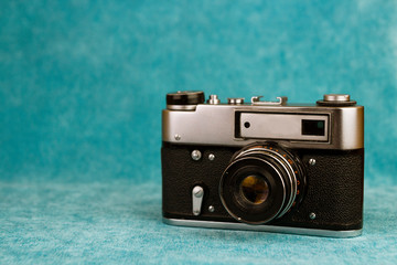 Old camera on a blue background. Sea holiday concept