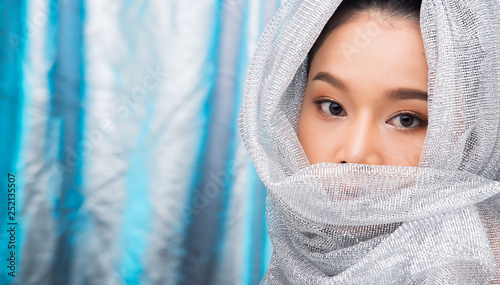 Beautiful Young Asian Black Hair Woman In Silver Blue Ice