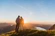Austria, Salzkammergut, Couple standing on mountain summit, enjoying the view