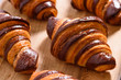 fresh homemade croissants with chocolate on wood surface