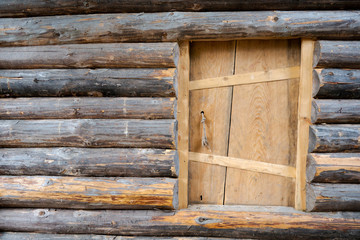 Small entrance door of old traditional wooden log house with copy space