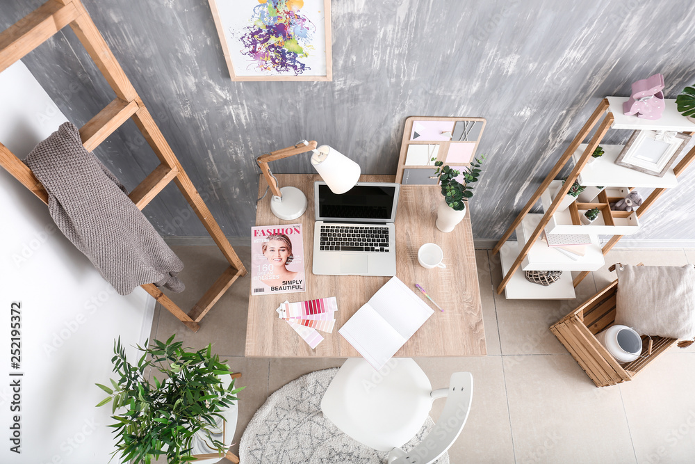 Stylish workplace with modern computer in interior of room
