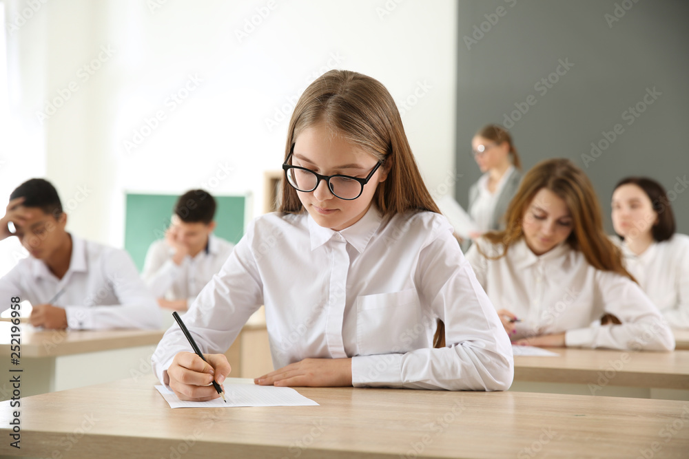 Girl passing school test in classroom