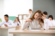 © Pixel-Shot - Pupils passing school test in classroom