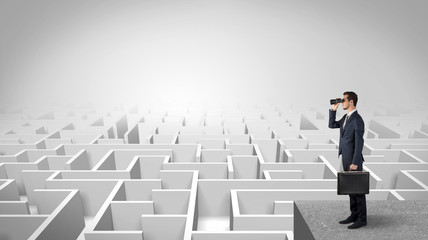 Wall Mural - businessman standing on maze and looking forward to the future concept