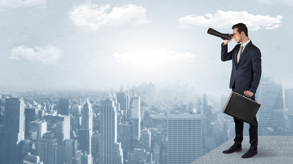 Wall Mural - businessman looking forward to a city with binoculars from skyscraper concept