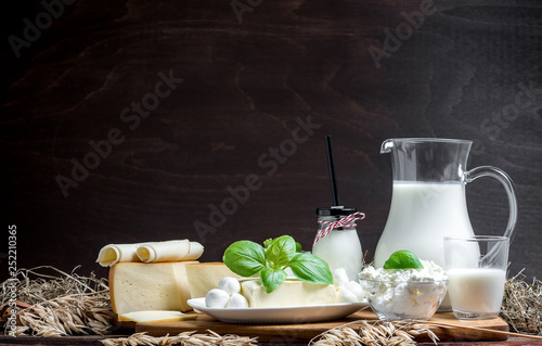 Fotografía Many fresh dairy products in front of a rustic vintage background