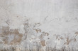 Gray wall ruined by time, bad weather and humidity. Cracks, mold, peeling paint and plaster. Texture, material background.
