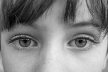 Black And White Macro Shot Of The Big Intense Eyes Of A Young Child