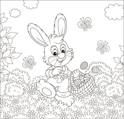 Wall Mural - Friendly smiling Easter Bunny with a basket of painted eggs walking among flowers on sunny spring day, black and white vector illustration in a cartoon style for a coloring book