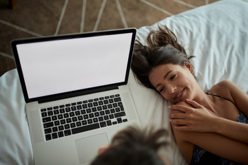 Wall Mural - Funny in bed - couple with laptop in the bed top view.