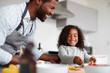 © Monkey Business - Father And Daughter In Kitchen At Home Making Pancakes Together