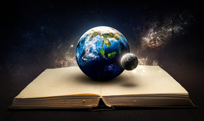 magic book with planet earth and moon in the space. knowledge of universe. elements of this image fu