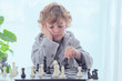 © ADDICTIVE STOCK - Boy holding figure on chess board