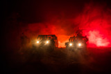 Fototapeta Paryż - War Concept. Military silhouettes fighting scene on war fog sky background, Fighting silhouettes Below Cloudy Skyline At night. Battle scene. Army vehicle with soldiers. army