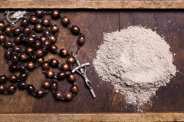 Wall Mural - Old rosary and ash - symbols of Ash Wednesday. Top view