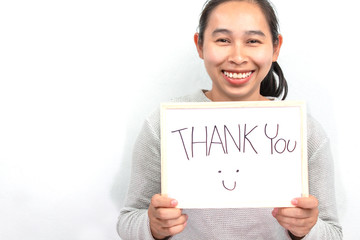 Studio shot of Asian woman holding a Thank you sign writing on whiteboard with handwriting. Isolated on white background.