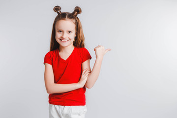 Emotional happy teen girl wearing a red t-shirt and horns shaped hair.