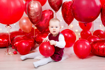 valentine's day concept - cute little baby girl with red balloons