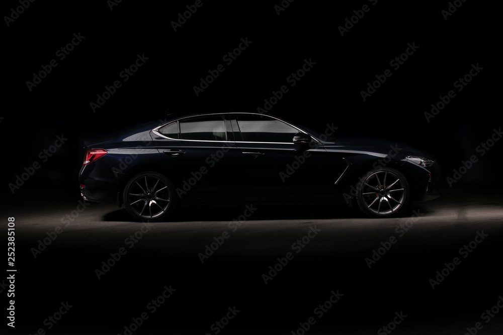 Four-door sport coupe. Silhouette of black sports car with headlights - obrazy, fototapety, plakaty 