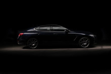 Four-door Sport Coupe. Silhouette Of Black Sports Car With Headlights