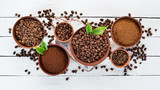 Fototapeta Kawa jest smaczna - Ground coffee and coffee beans. On a white wooden background. Top view. Free space for your text.