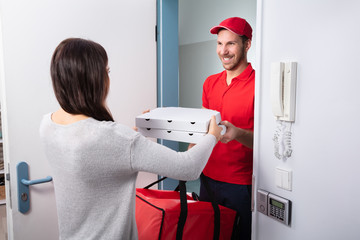 Man Delivering Pizza To Woman