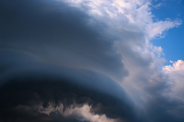 Wall Mural - Scary epic sky with menacing clouds. Hurricane wind with a thunderstorm. Stock background, photo