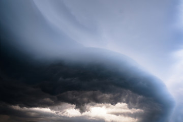 Wall Mural - Scary epic sky with menacing clouds. Hurricane wind with a thunderstorm. Stock background, photo