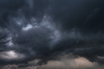 Wall Mural - Scary epic sky with menacing clouds. Hurricane wind with a thunderstorm. Stock background, photo