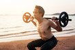 © Love You Stock - man with barbell on beach at sunset. health and sport concept.