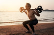 © Love You Stock - man with barbell on beach at sunset. health and sport concept.