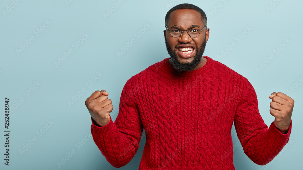 Serious Rage Mad black man roars and clenches fists, expresses anger, annoyed with ...