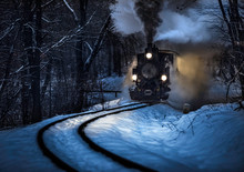 Budapest, Hungary - Beautiful Winter Forest Scene With Snow And Old Steam Locomotive On The Track In The Hungarian Woods Of Huvosvolgy At Night