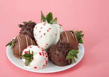 Variety Of Chocolate Covered Strawberries On A Plate. Dark, White And Milk Chocolate On A Pink Background. Side View