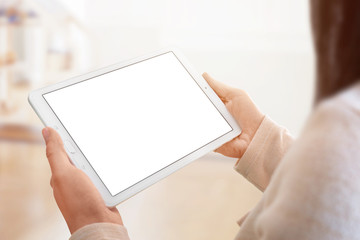 Leinwandbilder - Tablet mockup closeup. White tablet in woman hands. room and sunlight in background.