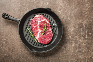 Wall Mural - Fresh ribeye steak and spices on a pan