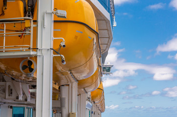 Sticker - Rows of  yellow lifeboats on the deck of a luxury cruise ship