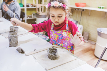 Wall Mural - Little Girl At Pottery Workshop Working With Clay