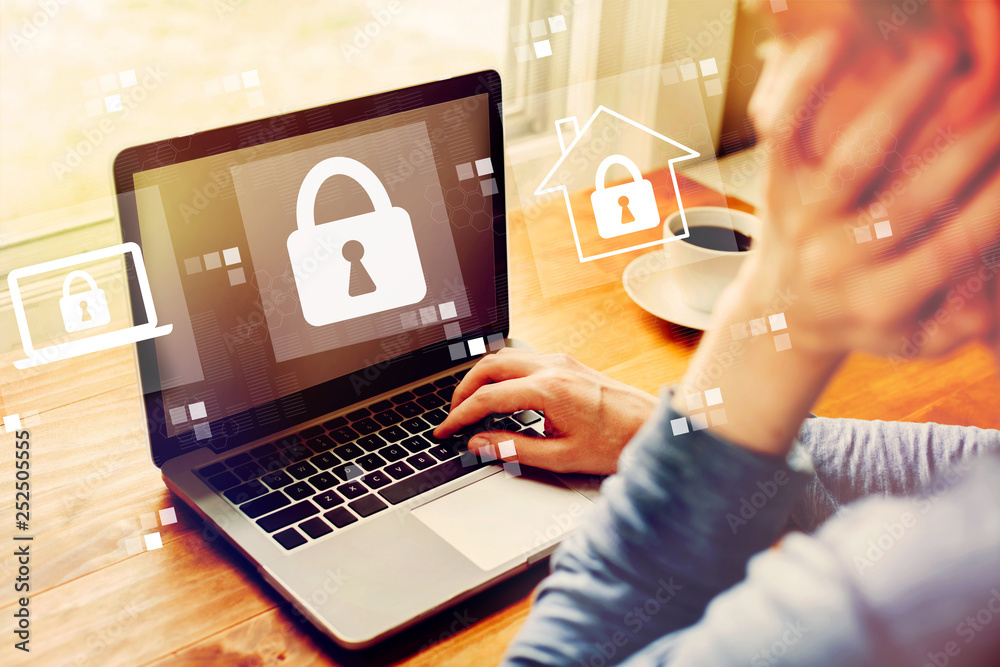 Man Using Computer Cyber Security Cyber security with man using a laptop computer Stock Photo | Adobe Stock