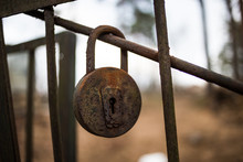 Rust Lock Hanging On The Iron Rod Of The Gates