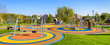 Panorama of colorful large playground in city park. Empty modern outdoor playground in summer. Beautiful urban place for kids games and sport. Scenic view of children ground.