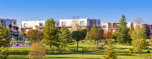 Public garden in modern town, panorama of green park in residential place