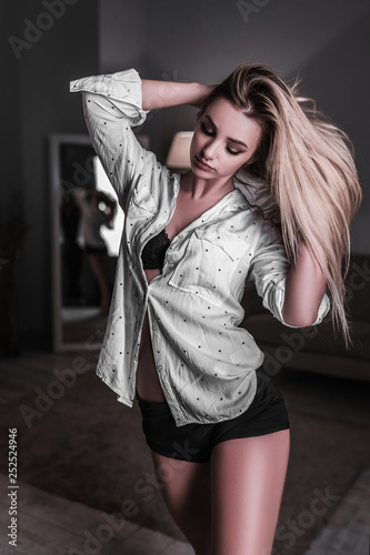 Beautiful Young Fashion Girl Posing In A Room At Home Female Model Tests Wearing A White Shirt And Black Underwear Stylish Fashion Photography In The Studio Buy This Stock Photo And
