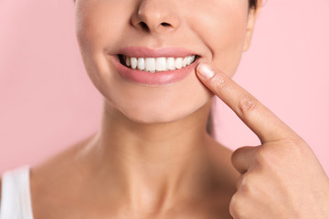 Wall Mural - Young woman with healthy teeth on color background, closeup