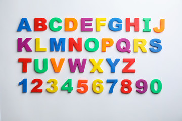 Plastic magnetic letters and numbers isolated on white, top view