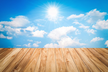 Wall Mural - wood table and blue sky with sun background