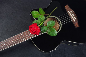 Wall Mural -   Black acoustic guitar and red rose.